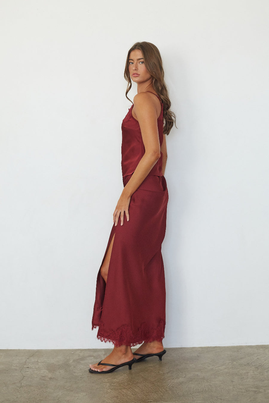 red-image | Red satin lace trim maxi skirt with side slit, side view on model