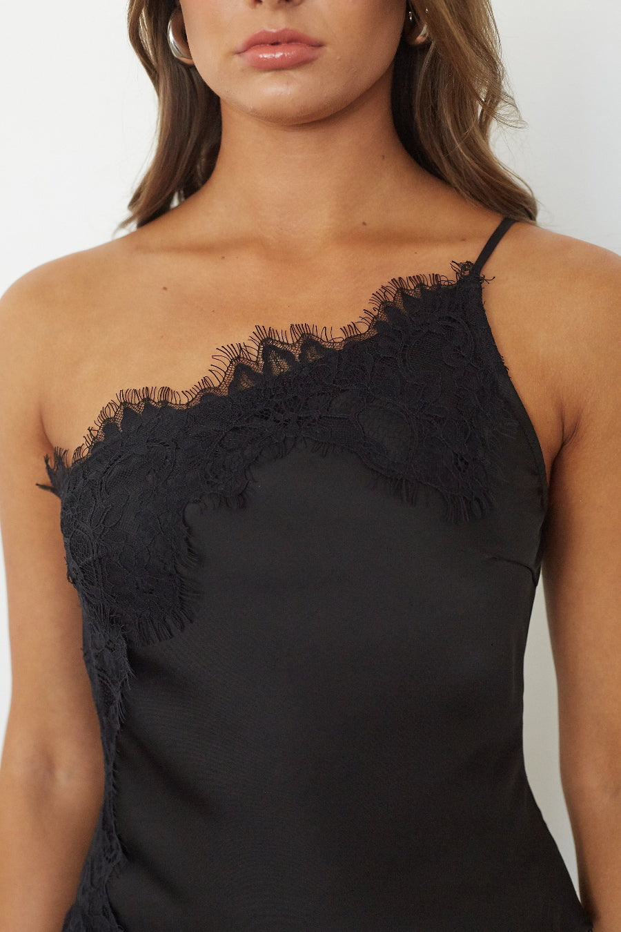 Detail close up shot of black asymmetrical top and skirt