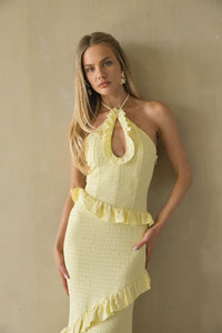 Woman wearing a yellow dress against a beige background