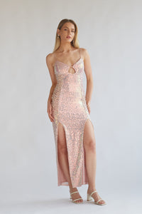 champagne pink sequin maxi dress with flattering side ruching, keyhole, and leg slits | 2024 prom dress boutique