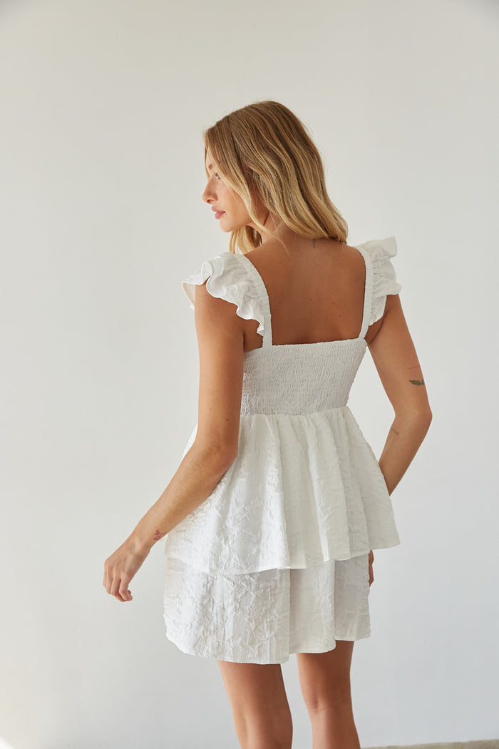 back view | white textured flutter sleeve fit and flare tiered mini dress