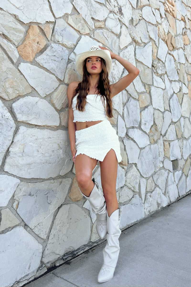 white mini skirt with side slit and matching twist front tube top