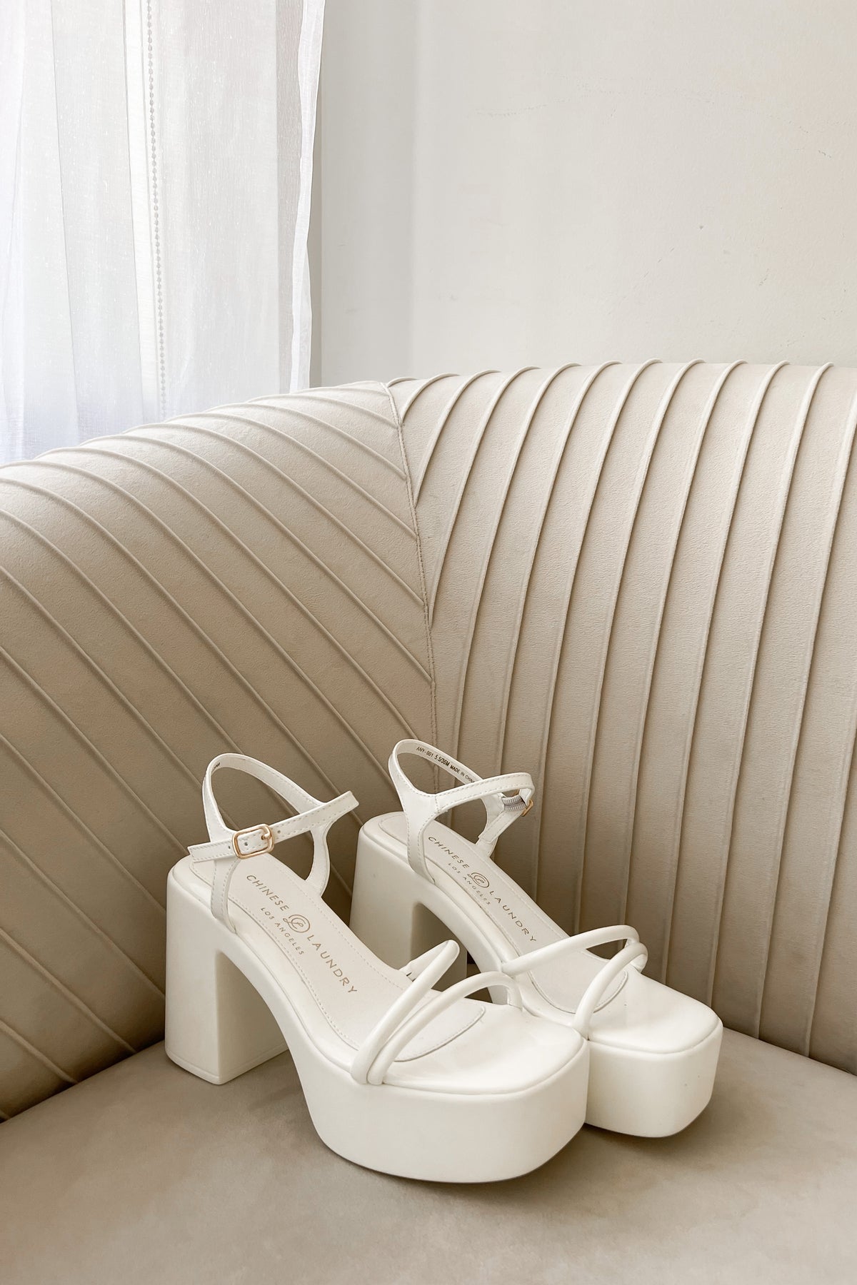 white heels on trendy sofa