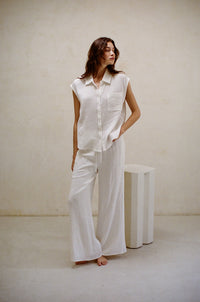 white gauze material matching set - sleeveless collared button up shirt and wide leg pants - resort wear