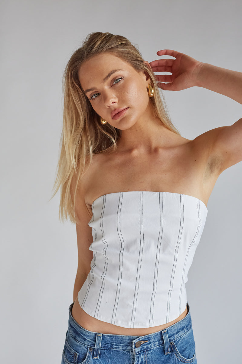 bright white strapless corset top with black stitching vertical lines | elevated basics for college outfits 