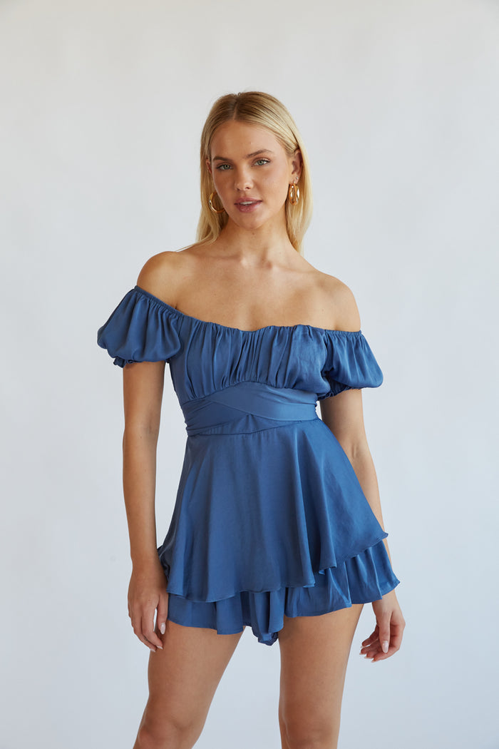 navy blue sorority recruitment romper - ruffle romper with puff sleeves hanging in front of a mirror