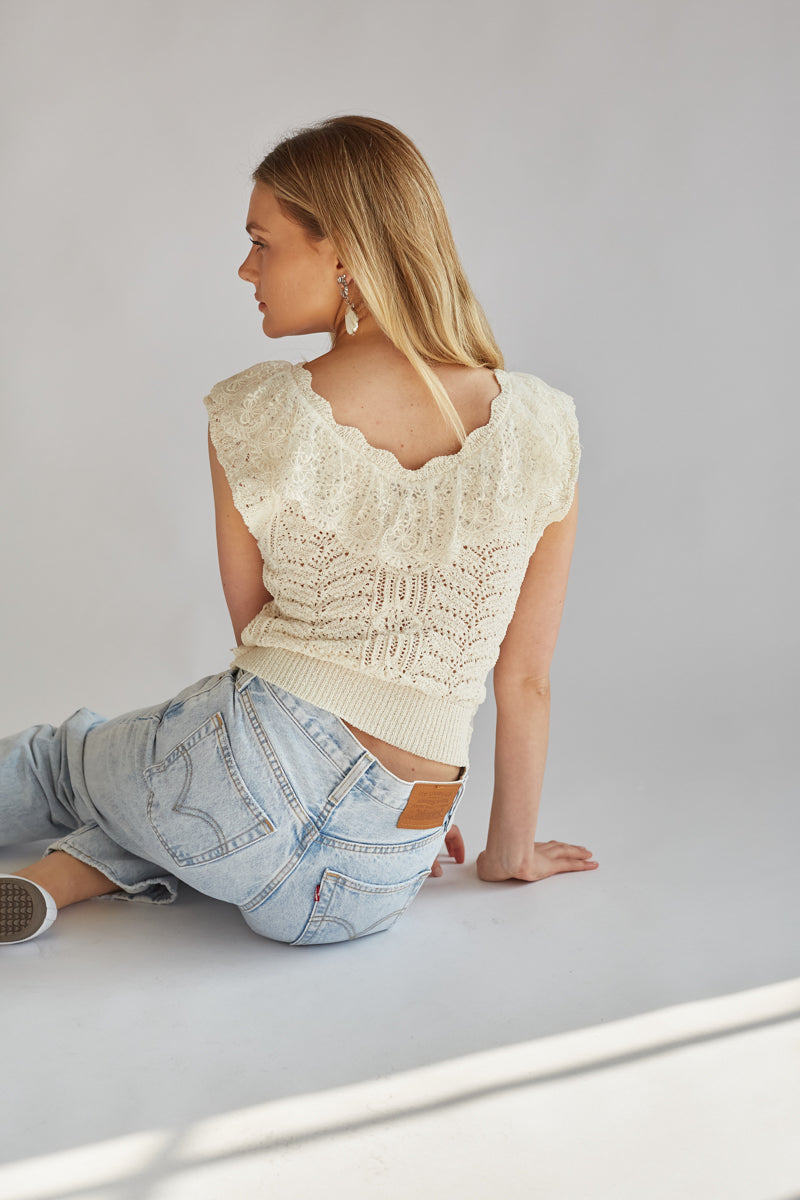 back view of sleeveless v neck ivory lace top with ruffle details 
