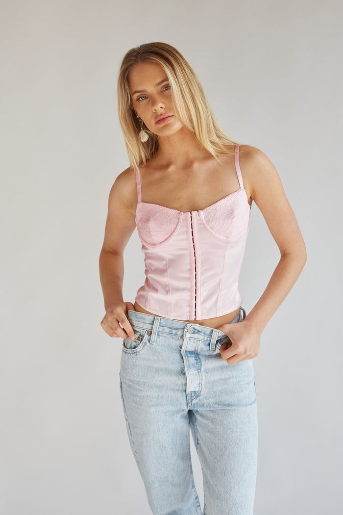front view baby pink corset top with satin bodice and lace cups - blonde model in front of white background | perfect top for spring break, sorority recruitment, and more