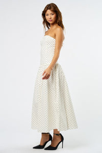 white-image | Woman wearing a strapless polka dot dress on a white background