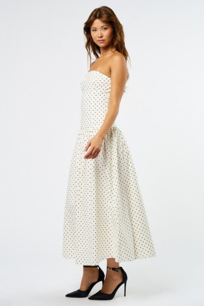 white-image | Woman wearing a strapless polka dot dress on a white background