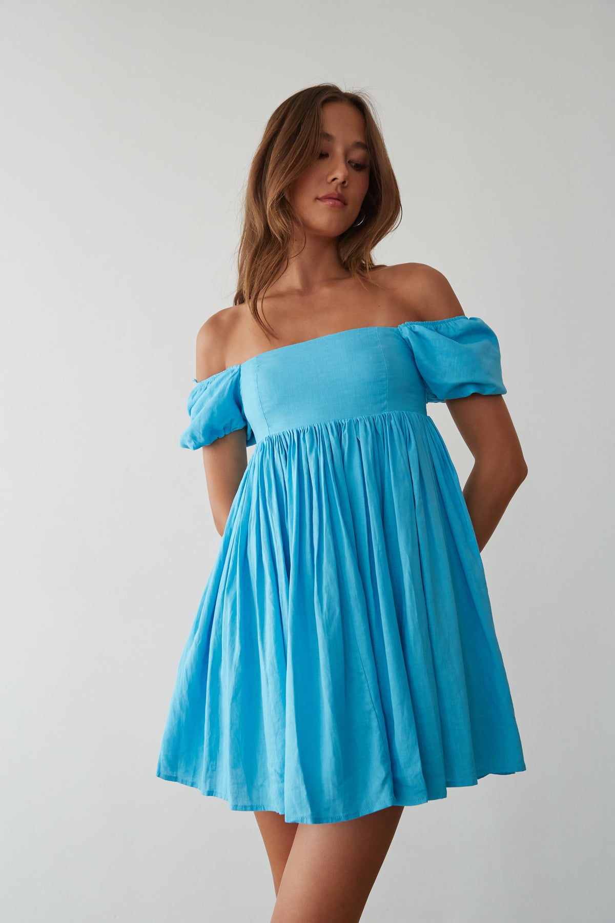 bright blue babydoll dress with ooff the shoulder puff sleeves and straight neckline
