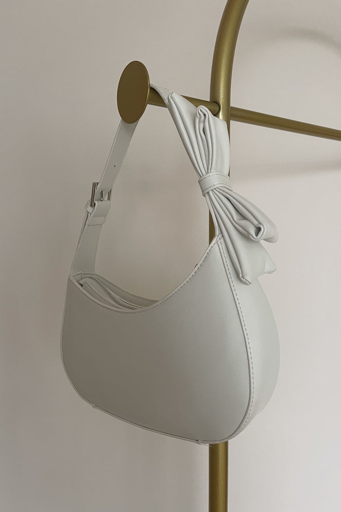 white faux leather hobo bag with adjustable bow strap | trending handbags for spring