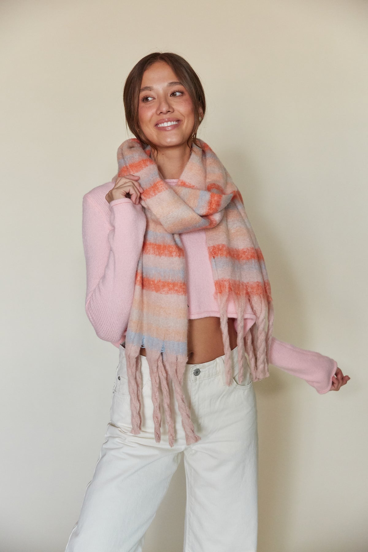 pink sweater with white jeans and rainbow trendy scar | winter outfit boutique 