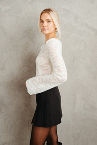 white ivory lightweight bell sleeve loose knit sweater - black high rise mini skort