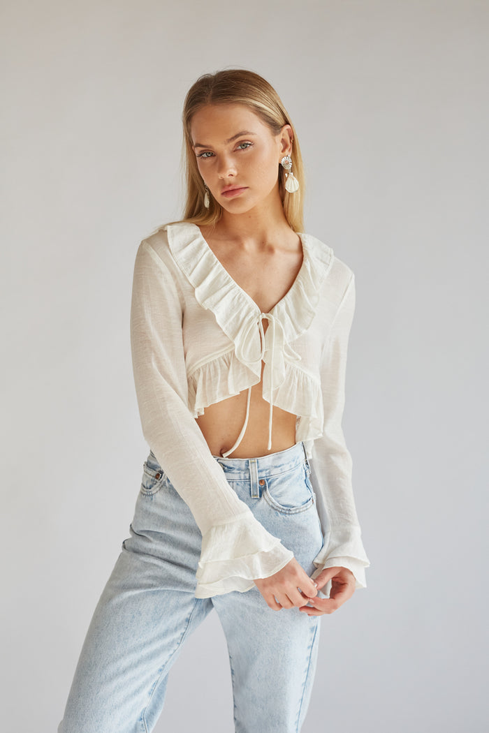 white long sleeve tie front top with ruffle detailing | white blouses for spring | white going out tops