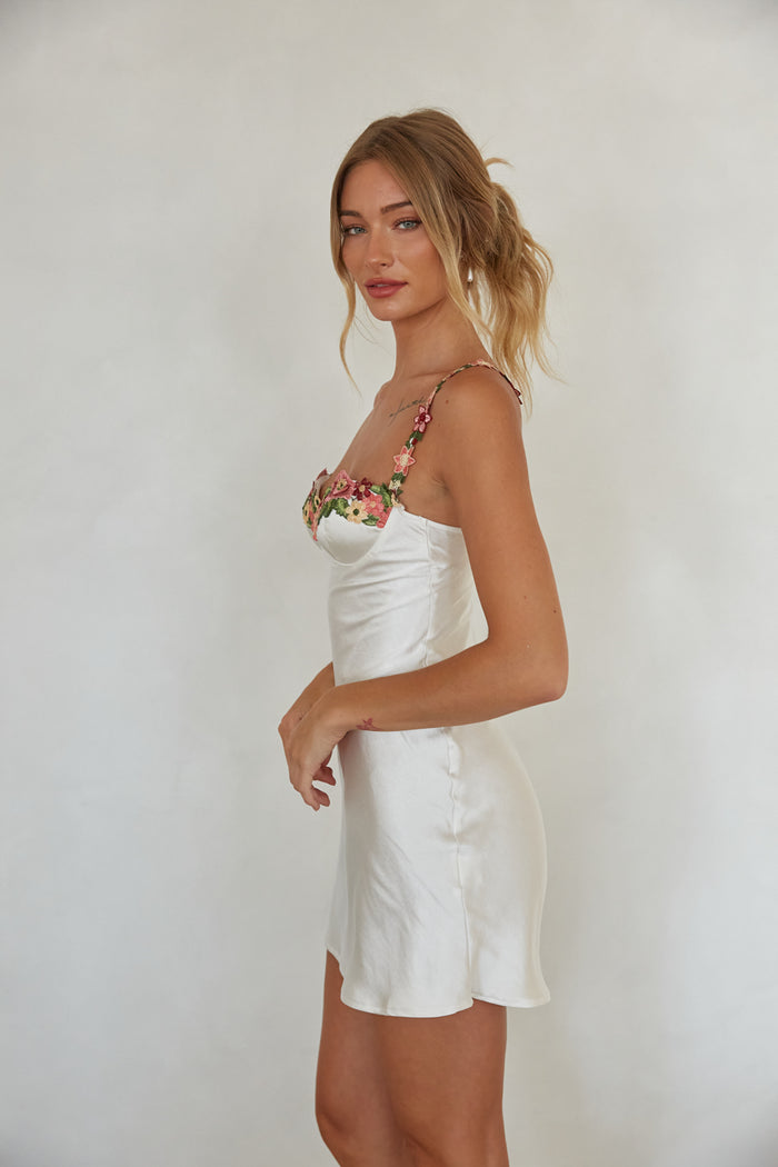 back view | white satin mini slip dress with floral embroidery trim | trendy summer mini dress