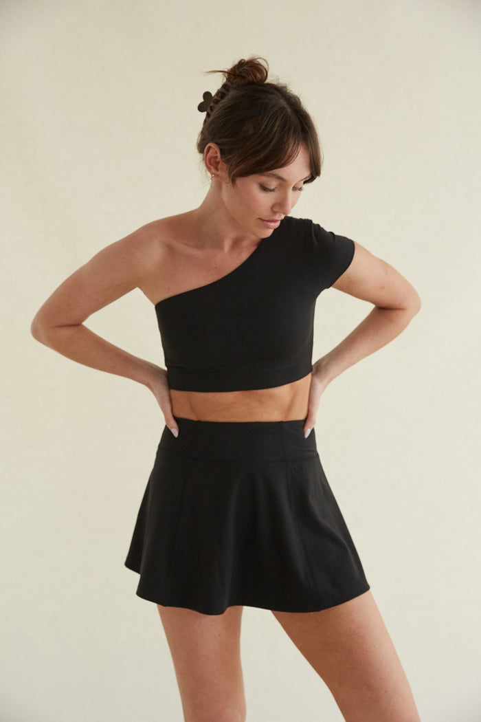 black high-waisted flare mini tennis skort with built in shorts and smoothing fabric