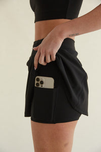 black high-waisted flare mini tennis skort with built in shorts with pockets
