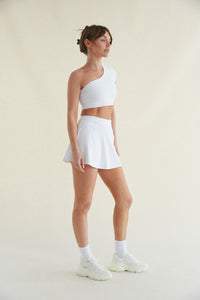 White high-waisted fit and flare tennis skort with built in shorts and smoothing fabric