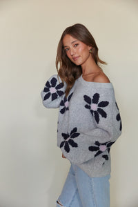 grey cozy knit sweater with dark blue daisy pattern |must-have sweaters for winter 2023