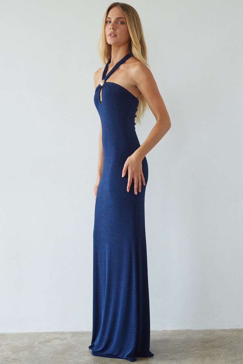 Woman wearing a blue evening gown against a white background