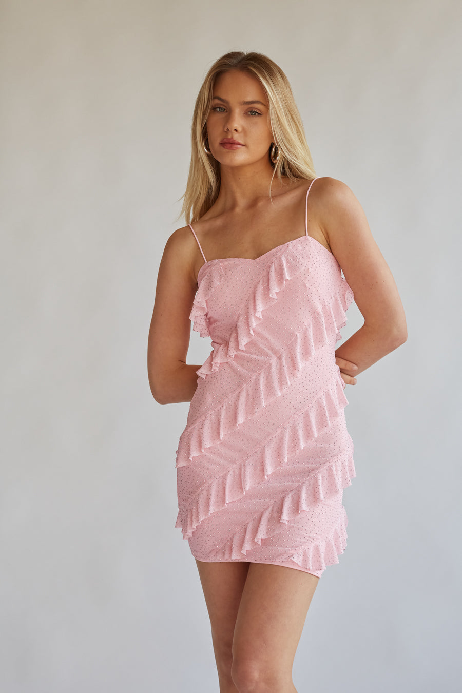 front view baby pink mini dress with asymmetrical ruffles and mesh material