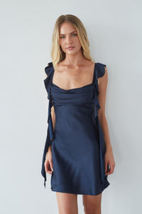 blue-image | Woman wearing a navy blue dress against a white background