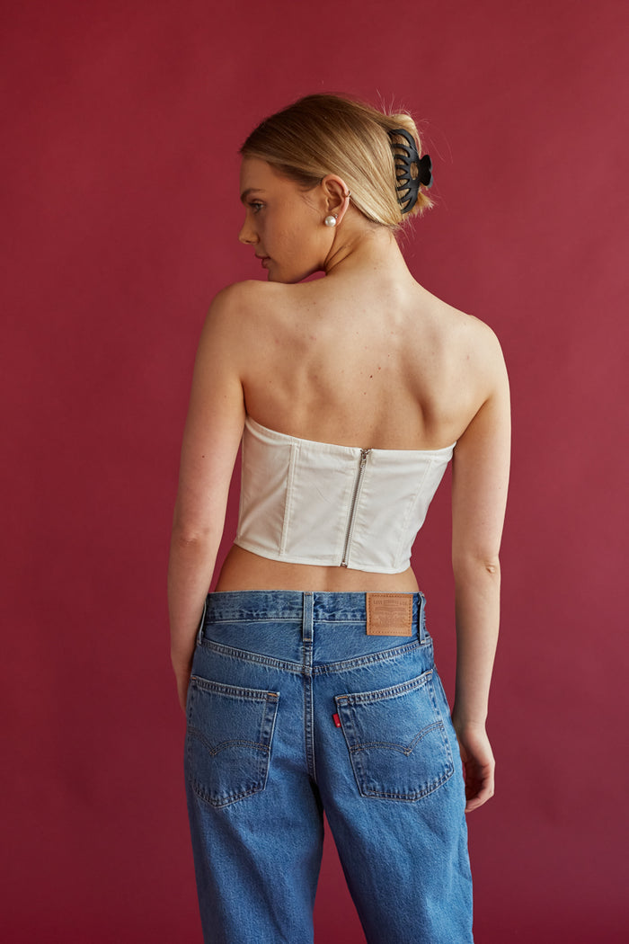 white lace detailing strapless corset top with black bow detail | white crop tops for spring 