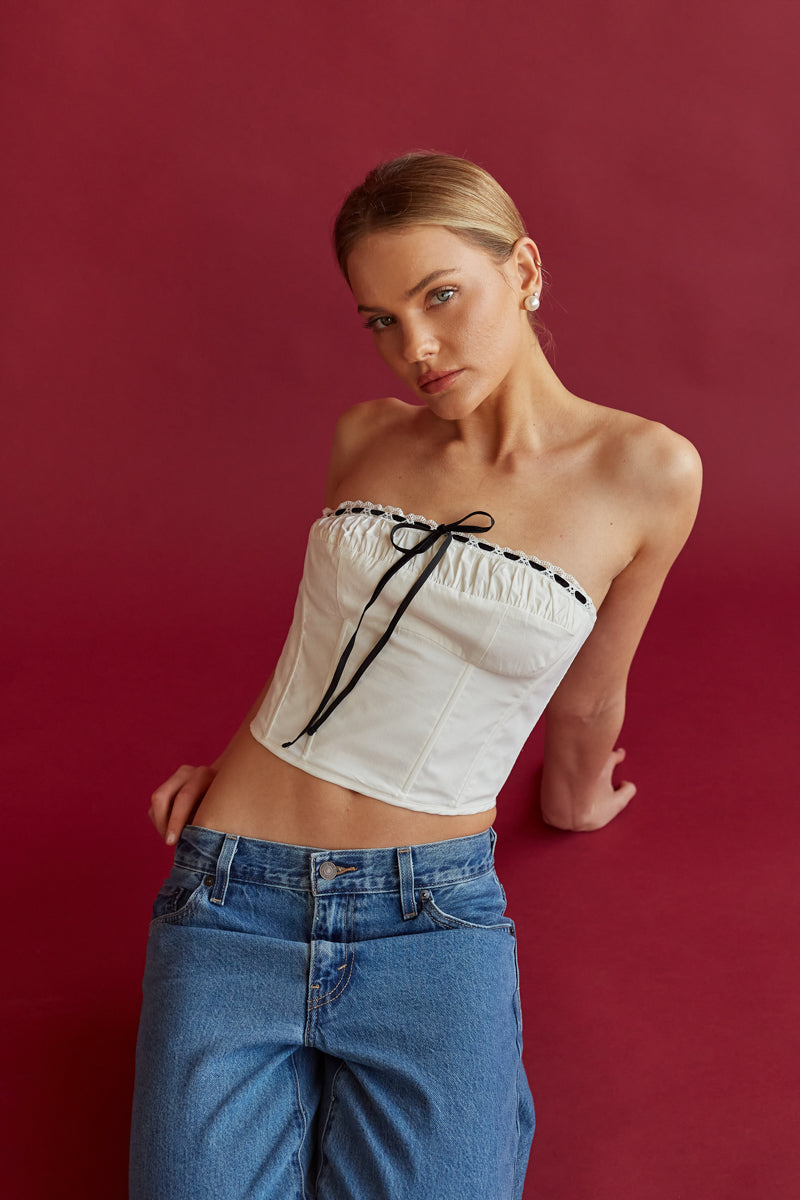 white bustier top with black lace front detail and ruched bust | white bustier tops for summer | white going out top