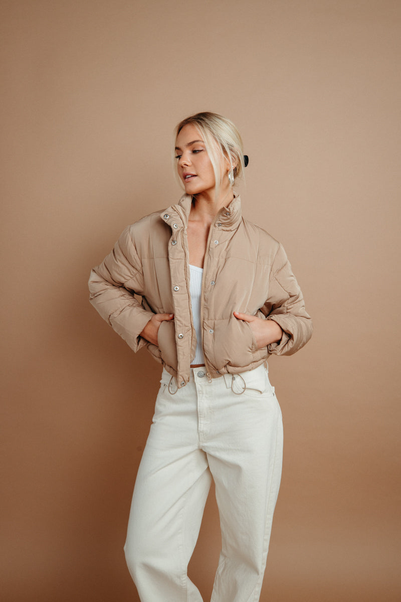 beige puffer jacket with front pockets and collared high neckline 