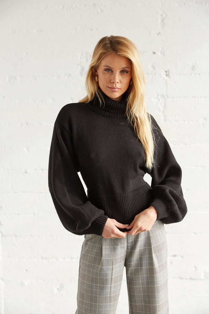 This sweater has a relaxed fit and long balloon sleeves. 