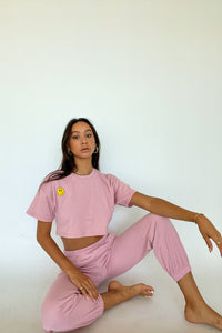 Sitting pose in pink joggers