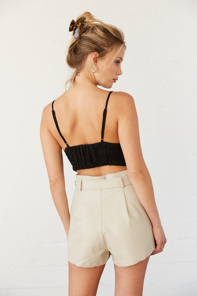 The back of this crop top has a ruched elastic detail. 