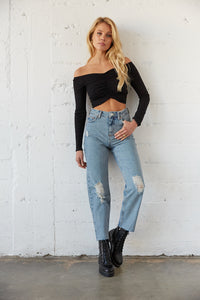 High waisted denim jeans with distressed detailing. 