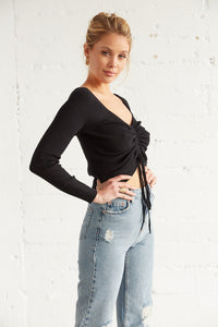 The side of this top has long ribbed sleeves and a cropped fit. 