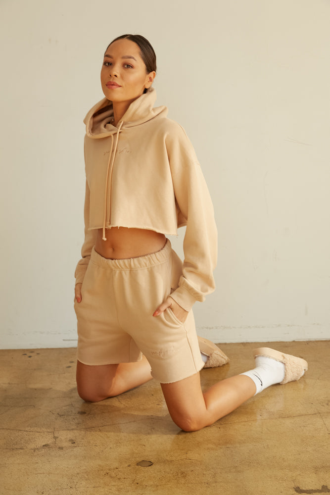 Cropped hoodie with raw hem.