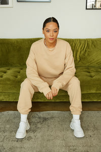 Tan sweatshirt and jogger pants.