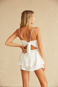 Back view of white ruffle romper with back tie detailing 