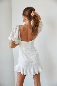 white ruffled mini dress, bridal shower mini dress | low back mini dress with ruffle hem and puff sleeves | white graduation dress