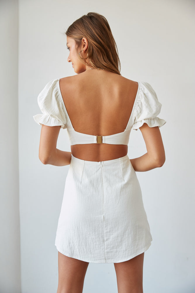 little white dress with open back and puff sleeves