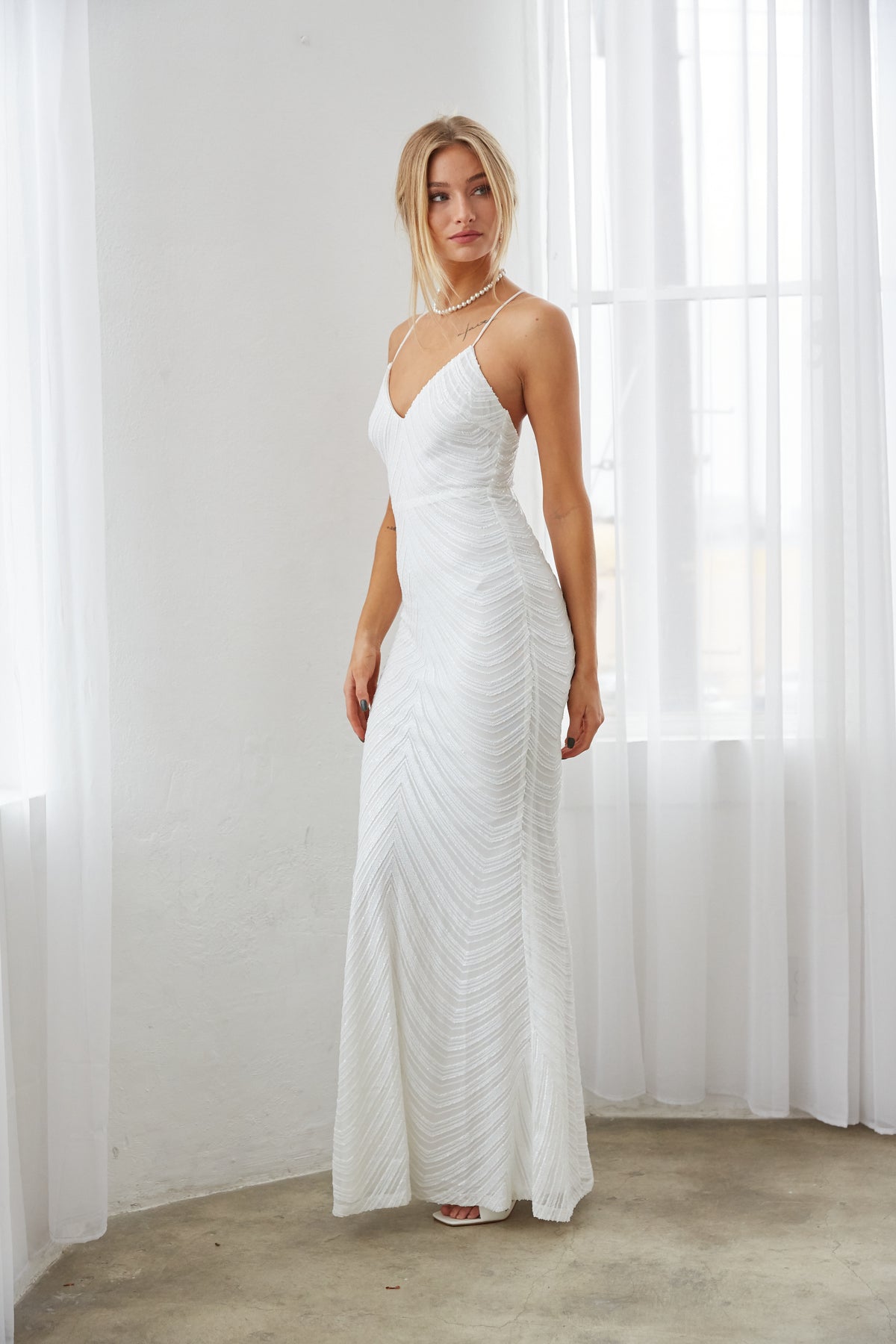 white sequin maxi dress - long white wedding dress - mermaid style wedding reception dress - bachelorette party outfit inspo - elegant bridal shower outfit