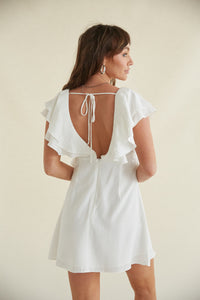 white open back dress with ruffles