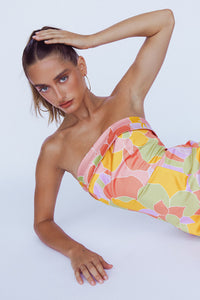 front view model laying down wearing pink green yellow orange purple floral dress